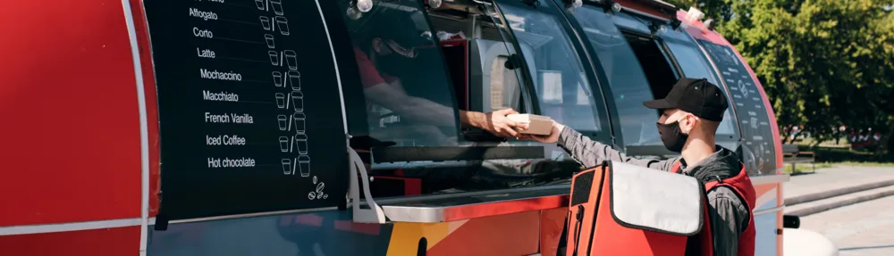 Delivery rider with an insulated bag ready to deliver a food cart order